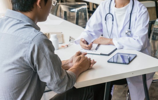 Article: Bridging the Gap: How Nurse Practitioners Support Mental Health Care by The Therapy Centre - NP talking to a patient with clipboard on table